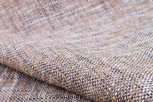 Preview: Beige upholstery fabric textile texture. shallow depth of field