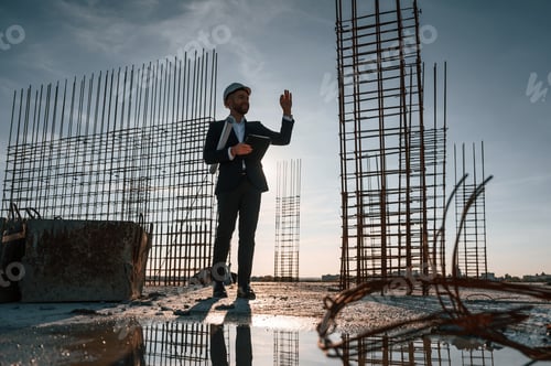 Preview: Beautiful background with evening sunlight. Businessman is on the construction site