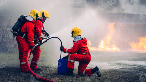 Preview: Fearless Firefighters Battling Blaze with Water and Extinguishers.