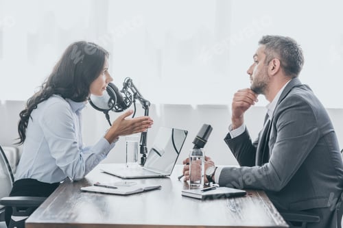 Preview: pretty radio host interviewing businessman in broadcasting studio