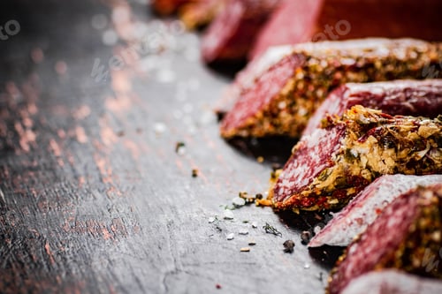 Preview: Various salami sausage on the table in a row.