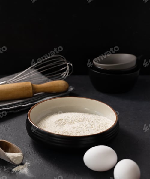 Preview: Organic baking ingredients. Flour, eggs and rolling pin on a dark background.