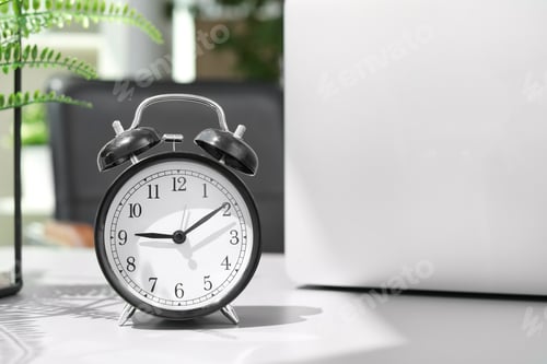 Preview: Alarm clock on table in office. Time to work