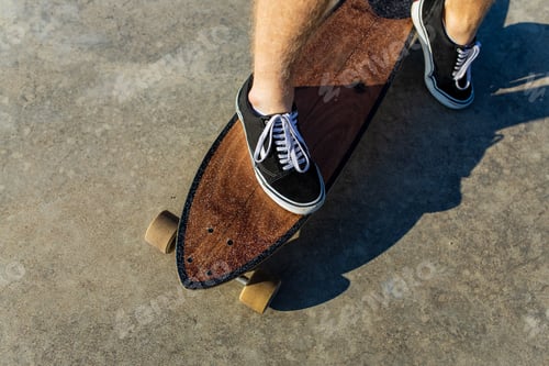 Preview: close up photo of man skateboarding near river at sunny summer day