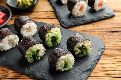 Preview: Tasty sushi rolls served on wooden table