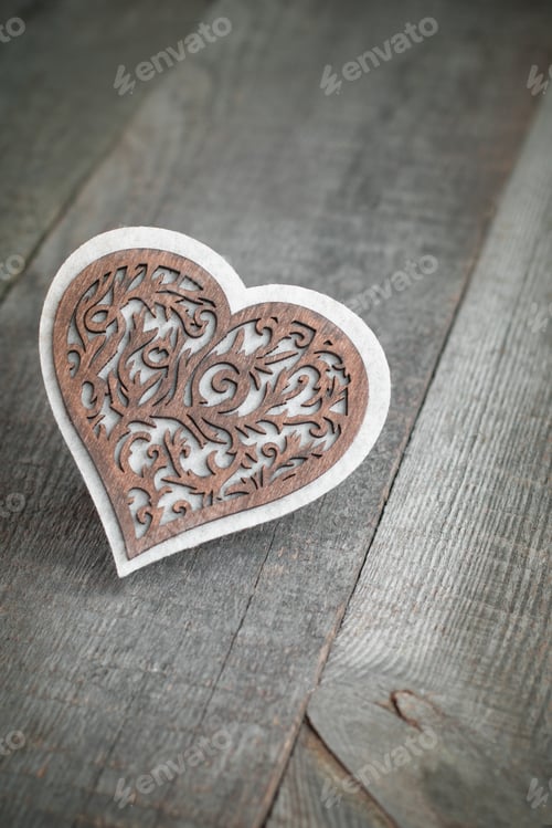 Preview: Valentine's card. Wooden carved heart over wooden table background with copy space.