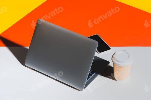 Preview: laptop, smartphone and disposable cup of coffee