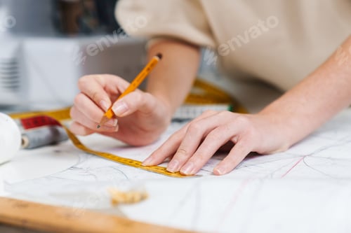 Preview: Close up of happy seamstress sewing