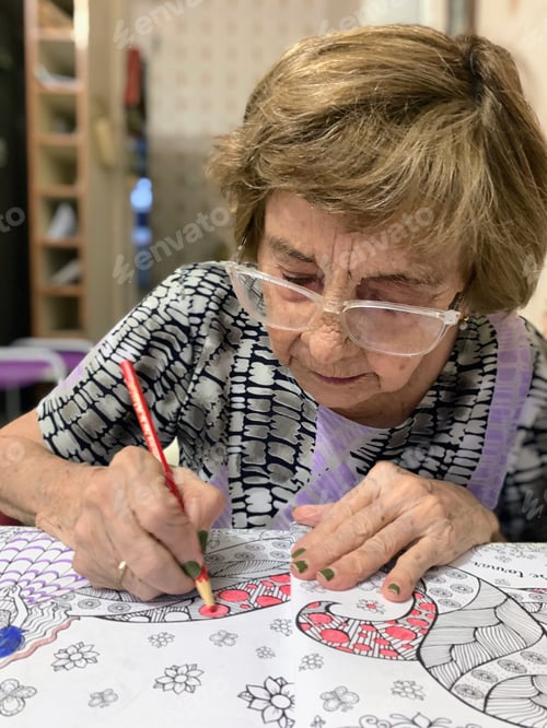 Preview: Elderly woman painting in her sketchbook