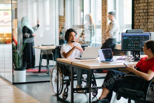 Preview: A young business group, including an African American businessman in a wheelchair, collaborates
