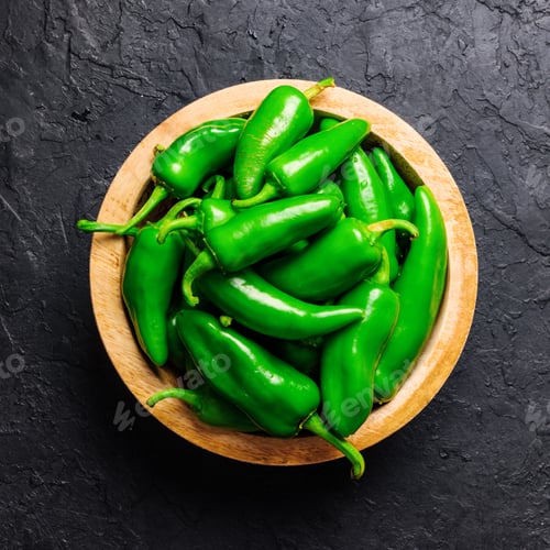 Preview: Green jalapeno hot pepper in wooden plate