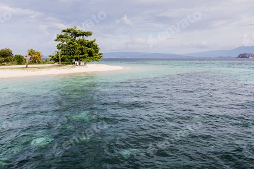 Preview: Small paradise tropical island with turquoise water, white sand and tree on beach