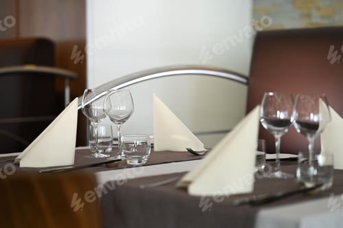 Preview: a table topped with a silver metal place setting surrounded by glassware