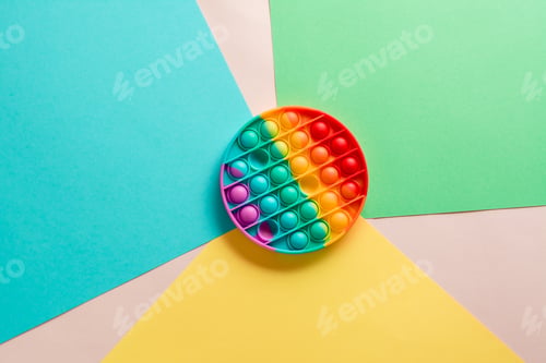 Preview: Silicone rainbow antistress toy in the form of a circle on a cardboard of different colors.