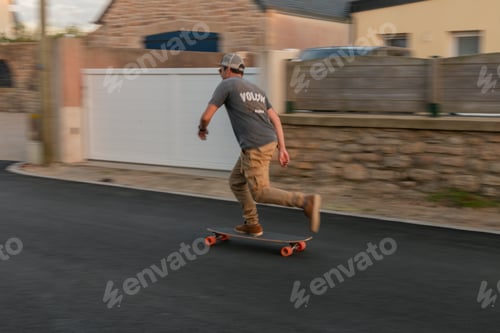Preview: A man riding his longboard on the road