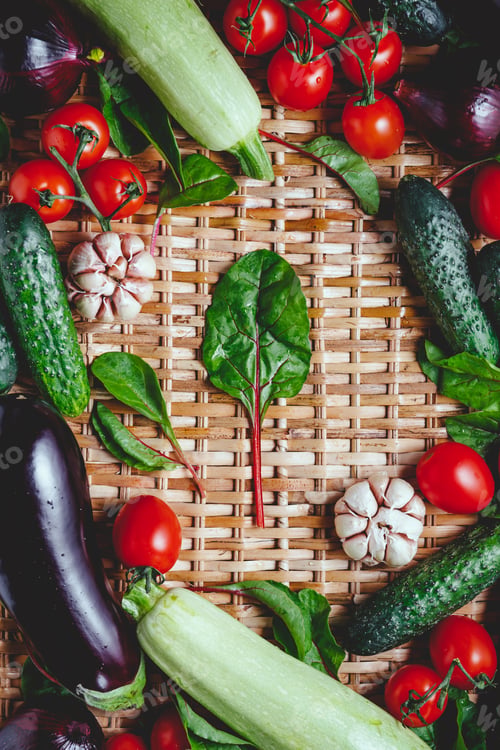 Preview: Various fresh vegetables on a rattan background. Healthy eating and cooking concept.