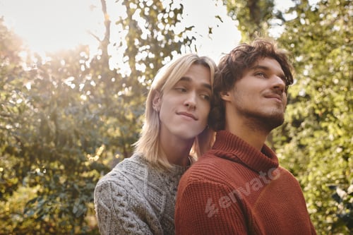 Preview: Capturing a moment of love and connection between two young men in a serene forest setting