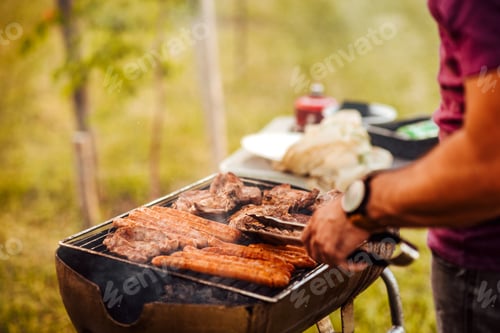 Preview: Preparing barbecue outdoors, close-up, copy space.