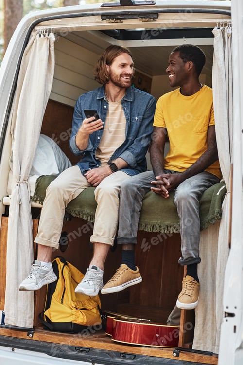 Preview: Friends using mobile phone in motorhome
