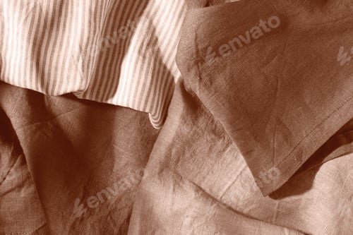 Preview: Mocha Mousse color of year 2025. Pile of cotton and linen serving napkins