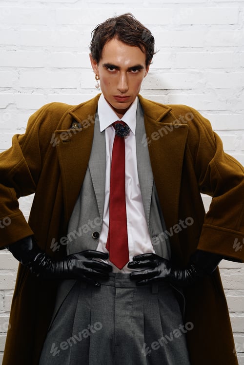 Preview: Stylish man exudes confidence in modern fashion against a minimalist backdrop