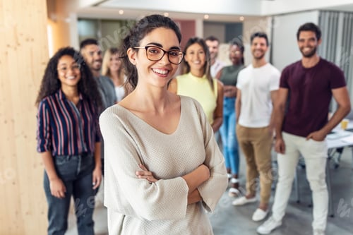 Preview: Successful business team posing for presentation of work in a coworking space.