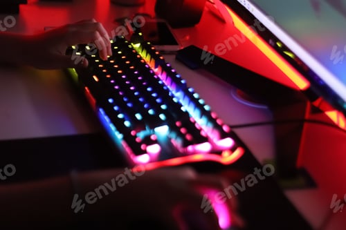 Preview: Gamer. A teenager is playing on the computer in the evening time. Keyboard computer,using technology
