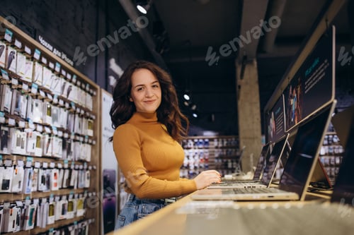 Preview: woman buying a laptop in tech store