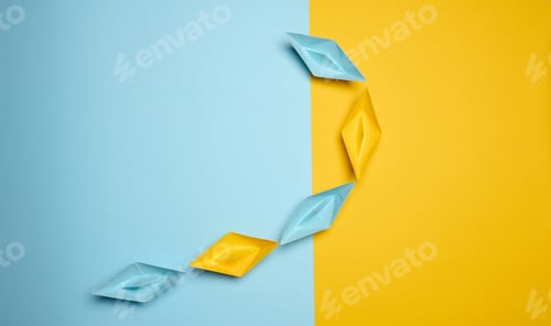 Preview: Paper boats on a yellow background, top view, representing the concept of unity