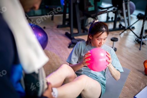Preview: Woman Exercising with Ball in Gym Environment