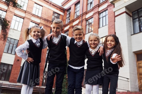 Preview: Group of kids in school uniform that is outdoors together near education building