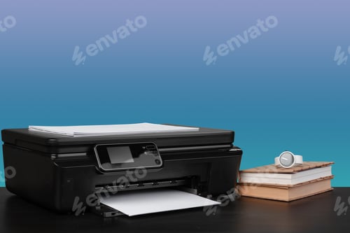 Preview: Compact laser printer on black desk against blue background