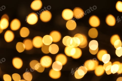Preview: Beautiful golden lights on dark background. Bokeh effect