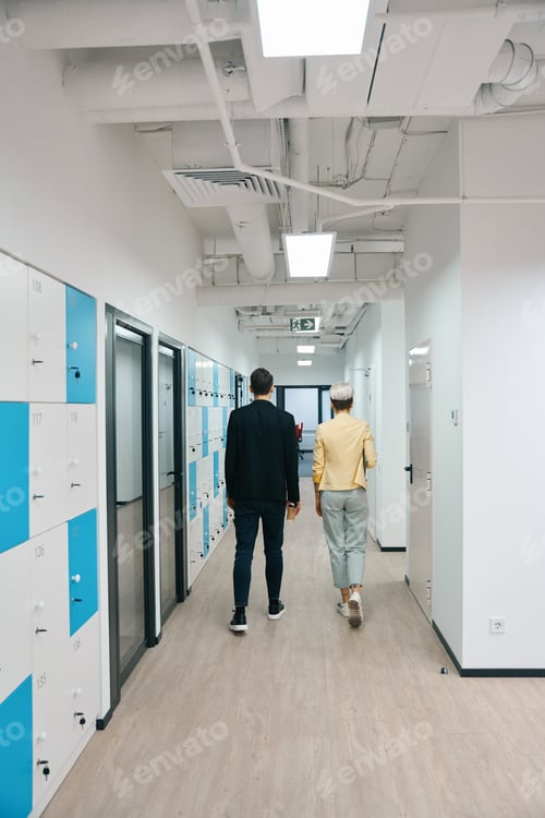 Preview: Colleagues walking along storage cells to office