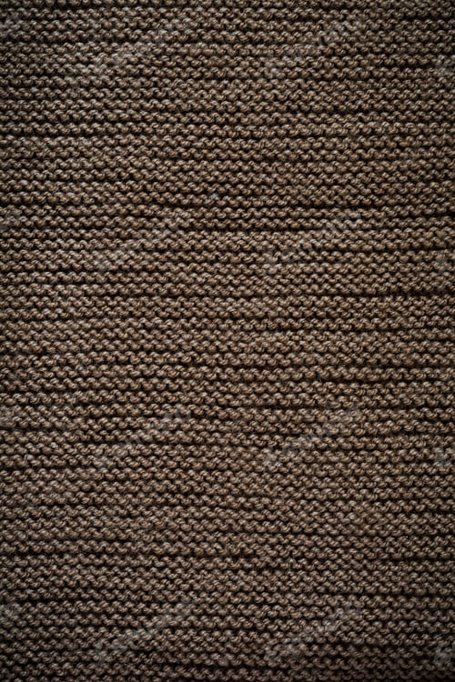 Preview: Brown knitted wool texture background pattern vertical background. Selective focus. Top view. Copy s