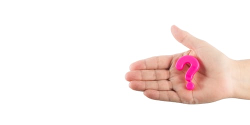 Preview: woman's hand holding pink plastic question mark