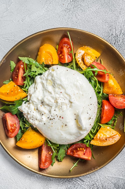 Preview: Italian Burrata cheese with cherry tomatoes and fresh arugula. White background. Top view