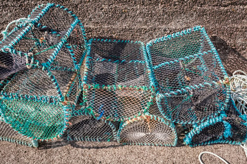 Preview: Colored fishing cage and bay with boats in Scotland