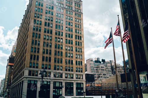 Preview: Waving flag of America near old high building