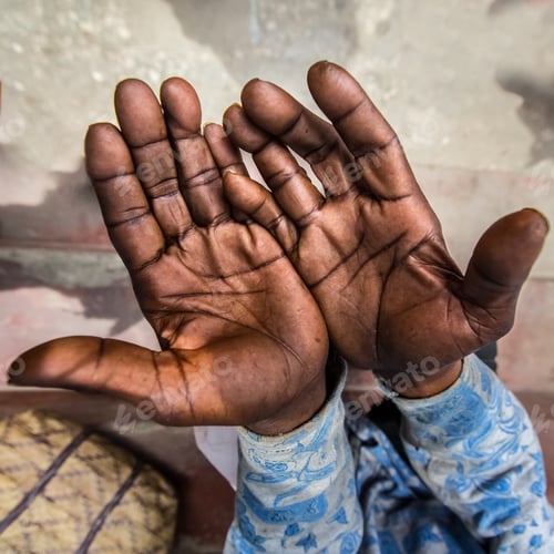 Preview: The calloused hands of a working man with dark skin tell a story of labor