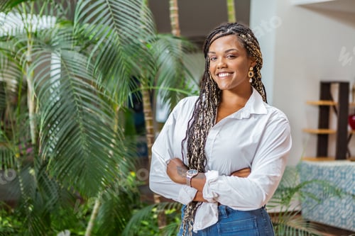 Preview: African American adult woman standing with her arms crossed and looking at the camera