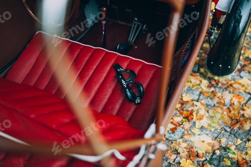 Preview: Closeup shot of safety glasses on the seats of a vintage car