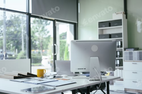 Preview: An office desk with a computer,documents,graphs represents a workspace for professionals analyzing