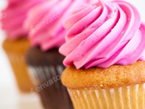 Delicious Cupcakes with Pink Frosting in a Row