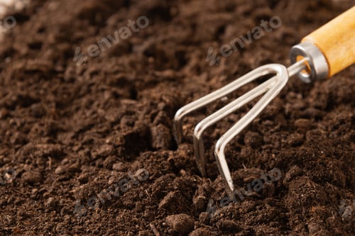 Preview: Garden hand cultivator on soil. Season gardening. Close up.