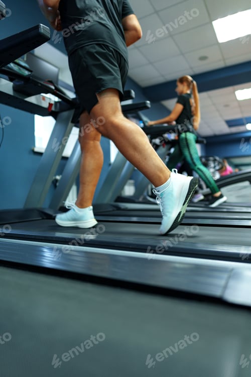 Preview: Fit man running on treadmill in a gym