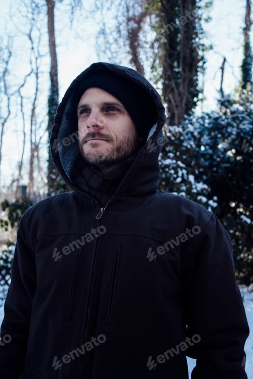 Preview: Man in a winter jacket against a snowy backdrop