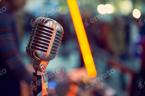 Preview: Close up of a professional vintage microphone with blurred lights in the background