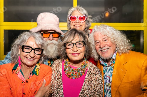 Preview: Group of happy senior friends with fancy clothing having party in the night