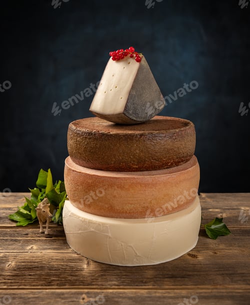 Preview: Wedge of cheese is balancing on top of another cheese